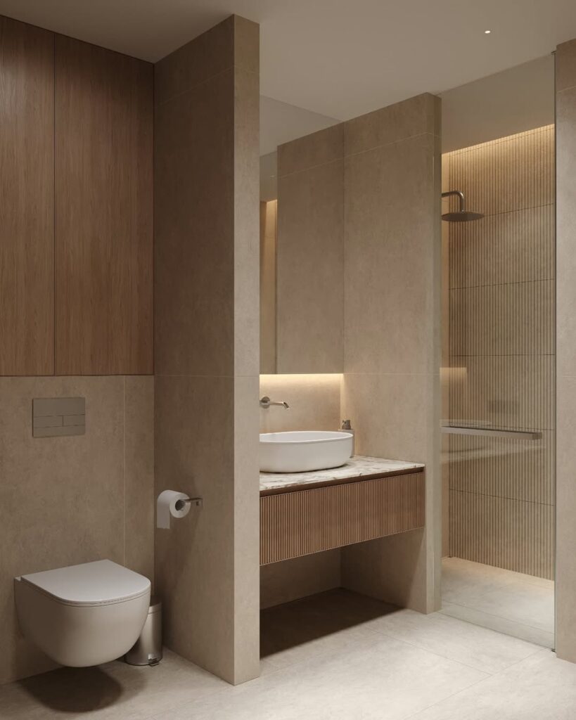 Contemporary bathroom with a wall-mounted toilet, fluted wood vanity, vessel sink, large tile finishes, and a walk-in shower with soft indirect lighting.
